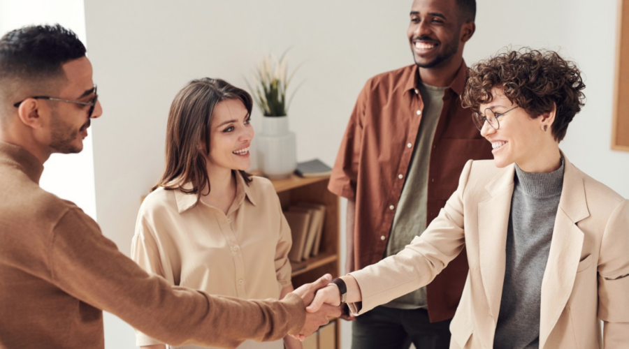 Professionals in an office setting shaking hands